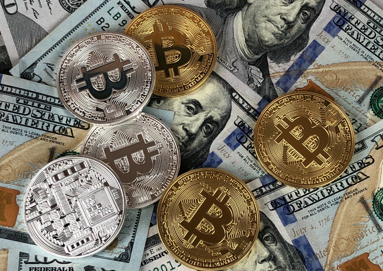 bitcoin and other currencies in a pile