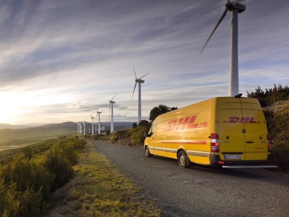 DHL truck driving on a road between windmills