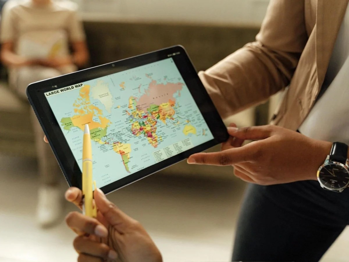 two people looking at a map on a tablet
